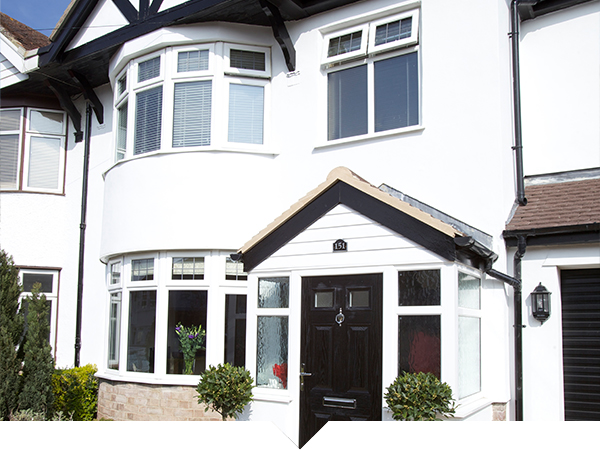 A beautiful bay and bow window installation on a traditional home, featuring a sleek design and clear views.